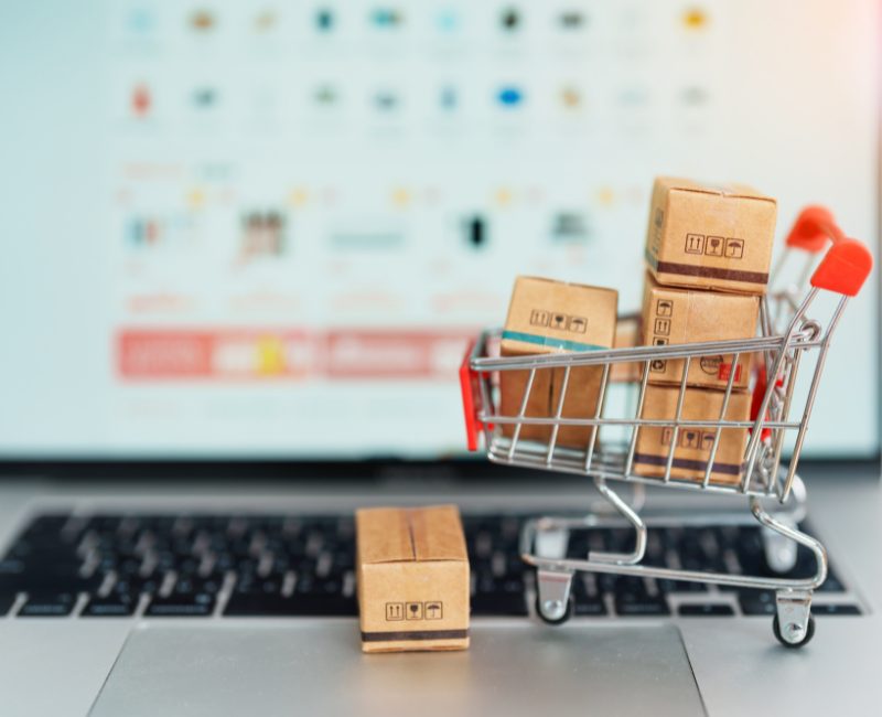 A shopping cart full of parcels on a laptop keyboard